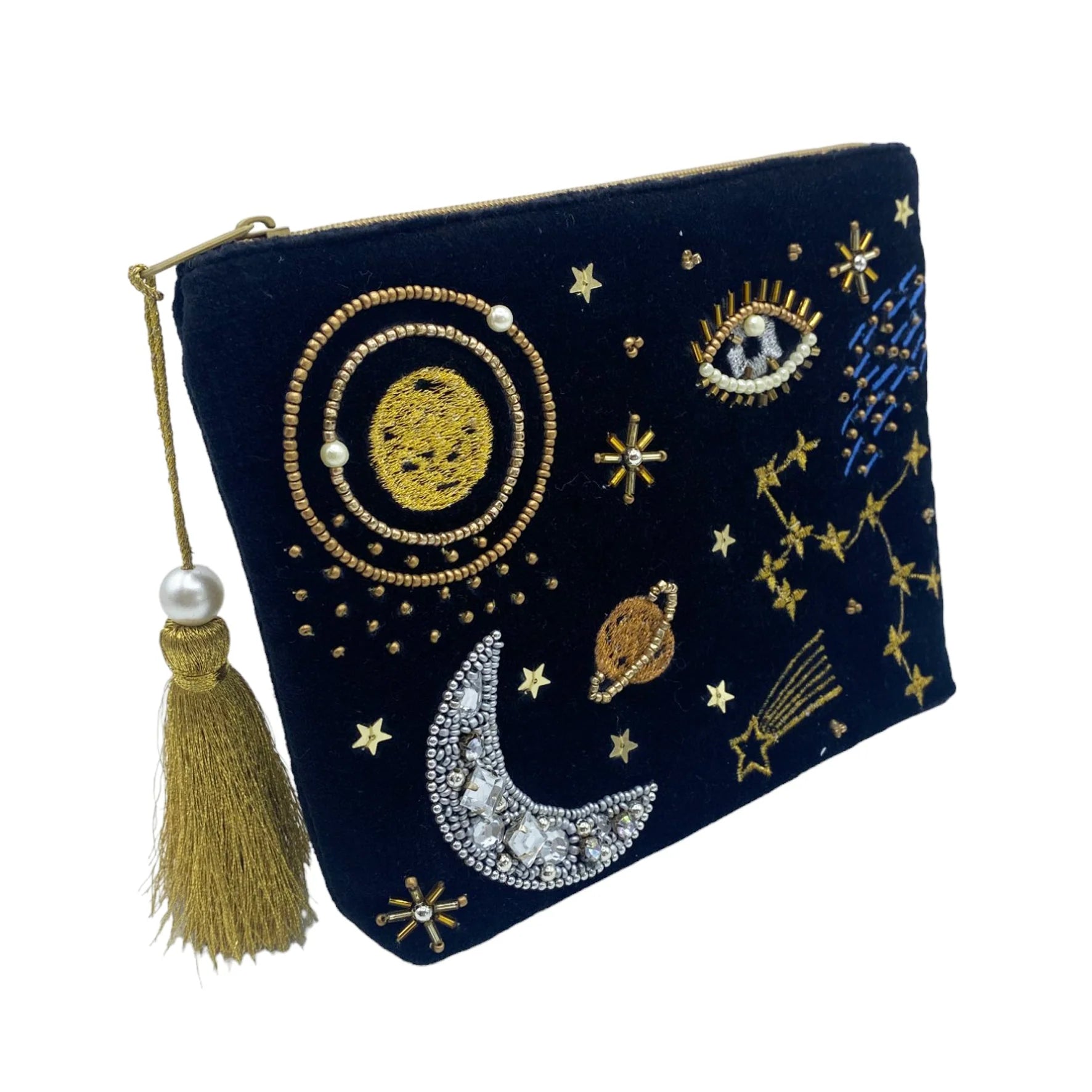 A navy blue zipped cosmetic pouch featuring gold and silver embroidered celestial designs—stars, a moon, the sun, and an eye—with a gold tassel on the zip; ideal as a vegan-friendly make-up bag.