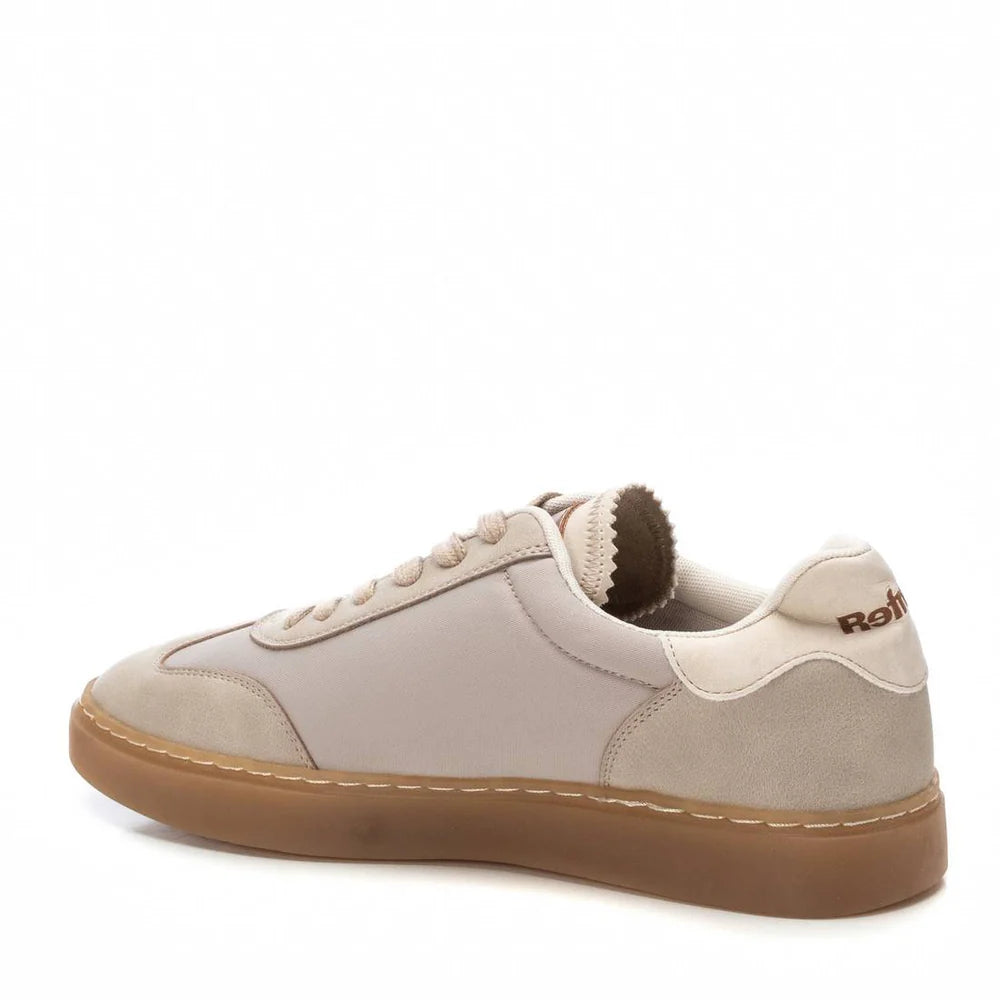 A beige and off-white trainer crafted from vegan material with brown detailing and a non-slip rubber sole, viewed from the back side angle against a white background.