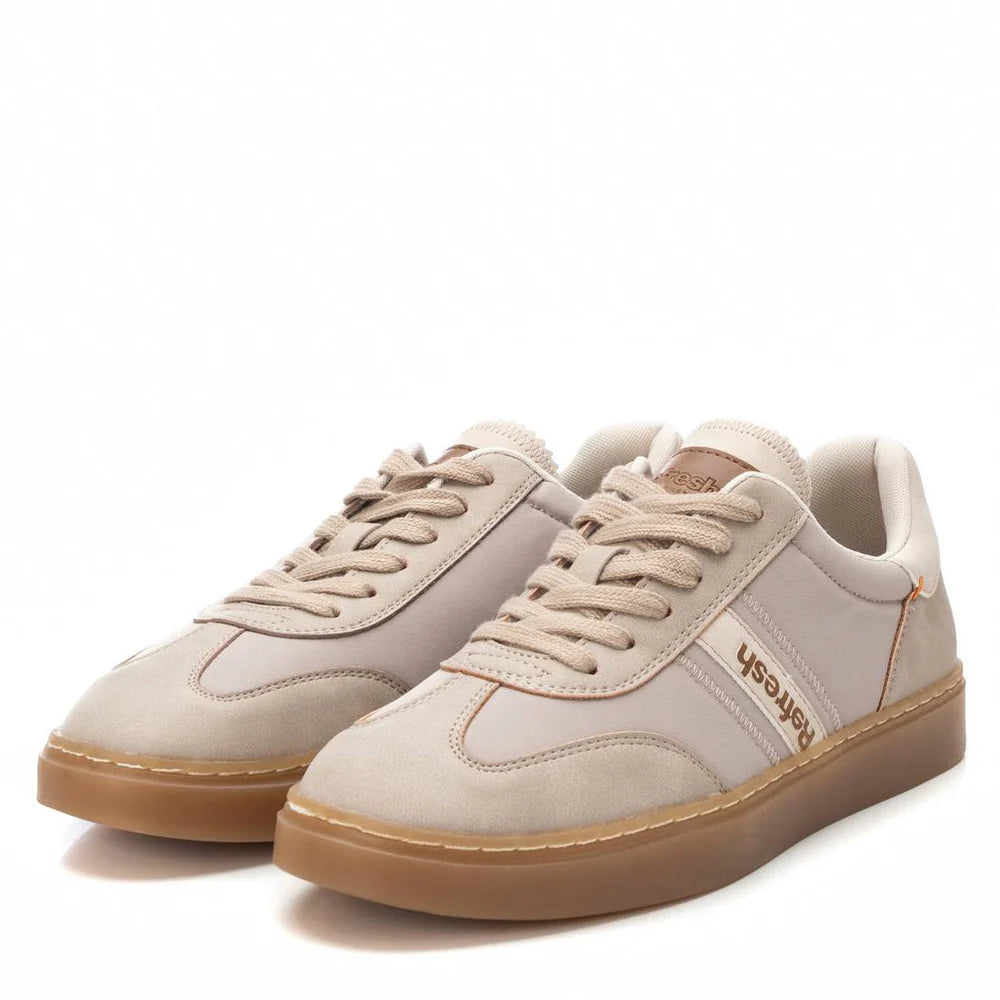A pair of beige low-top trainers made from vegan material, featuring gum non-slip rubber soles, lace-up fronts, and the FRESHCASH logo on the side.