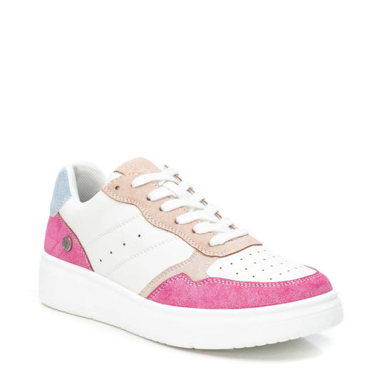 A white trainer with light pink and hot pink suede accents, a non-slip rubber sole, light blue heel detail, white laces, and a thick white sole.