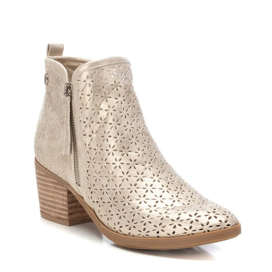 Beige ankle boot with a stacked heel, side zip fastening, and laser-cut floral pattern on the upper, inspired by the elegance of pale gold ankle boots for a touch of luxury.