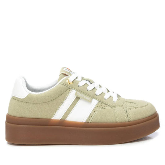 A beige and white womens trainer with white laces, white side stripes, suede detailing, and a thick non-slip rubber sole, shown from the side.