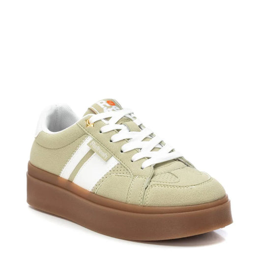 A beige and white low-top womens trainer featuring suede detailing, white laces, a thick non-slip rubber sole, and a logo on the tongue and side.