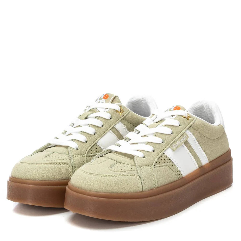 A pair of beige and white women’s trainers with suede accents, white laces, white side stripes, and thick non-slip rubber soles, displayed against a white background.