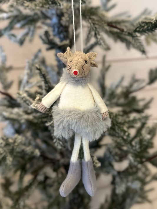 A festive decoration, this handmade reindeer with a red nose, grey boots, and a fluffy skirt hangs from a frosted Christmas tree branch—ideal for your festive décor.