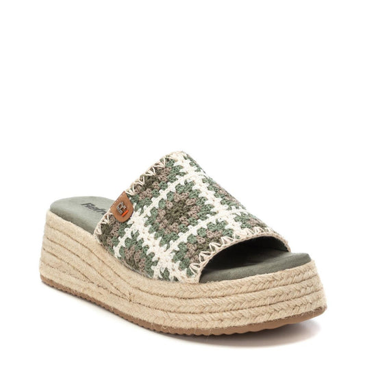 A stylish green and white woven platform slide sandal with an open toe and a thick jute-wrapped sole, these vegan-friendly Khaki Wedge Sandals are shown against a white background.