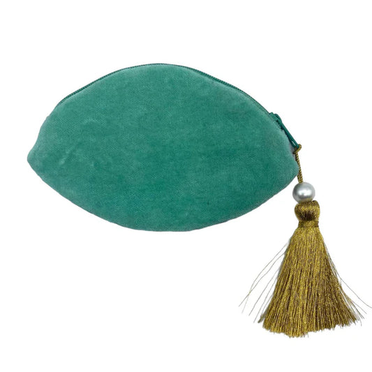 A green velvet Glimmer Eye Purse, vegan-friendly with a zip fastening, features a large gold tassel and a pearl bead for a luxurious touch—ideal as a stylish coin purse.