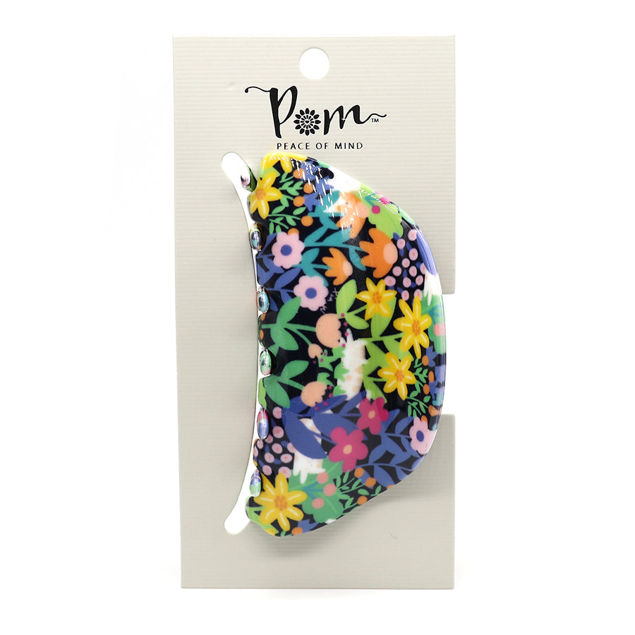Luxurious hair accessory: A vibrant black multi-floral mix claw clip, crafted from premium acrylic, is elegantly presented on a white branded card labelled POM Peace of Mind.