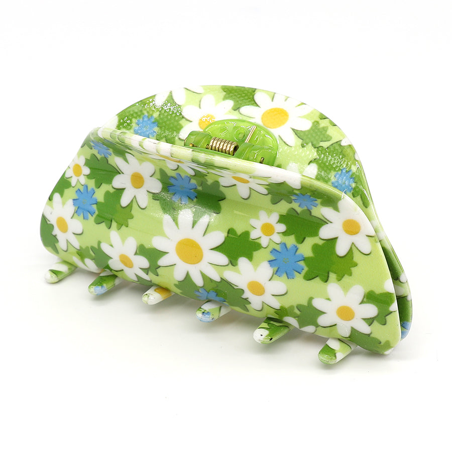 Luxurious floral hair claw in green, featuring a white and blue daisy pattern. Crafted from durable acrylic and displayed against a white background.