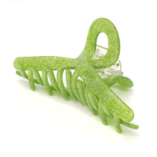 A vibrant lime glitter hair accessory, this butterfly-shaped claw clip features interlocking prongs and a reliable spring mechanism.