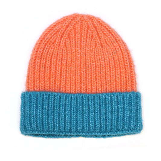 A cosy burnt orange beanie with a wide turquoise turn-up cuff, shown against a white background.
