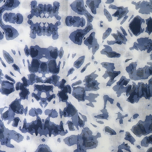 Abstract blue and white tie-dye pattern with symmetrical, intricate details resembling ink blots, crafted on an environmentally-friendly scarf using a recycled blend.