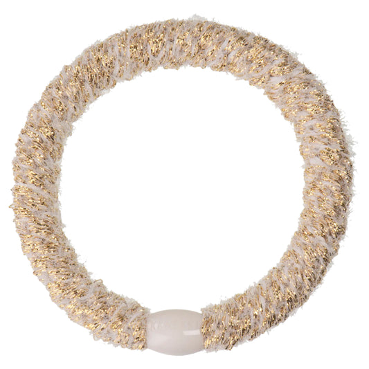 The Velvet Ivory Glitter Hair Band is a circular hair tie featuring a white and gold textured pattern and a central white connector, designed to prevent breakages.