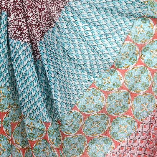 Close-up of an elegant accessory featuring colourful patchwork-style print fabric, with blue and brown geometric designs and circular motifs in shades of pink, teal, and gold.