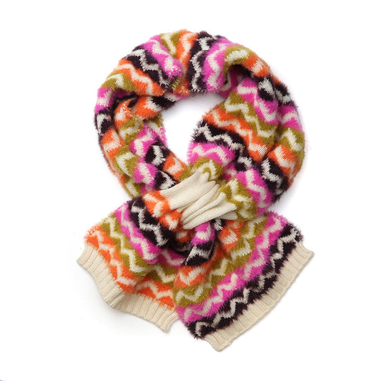 A colourful chevron scarf featuring zigzag patterns in pink, orange, green, black, and white, arranged in a loop with the ends tucked underneath—an ideal vegan-friendly accessory for autumn.