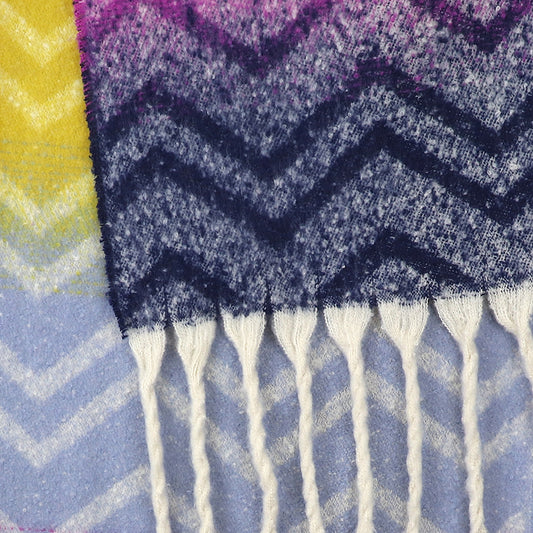 Close-up of an Ombre Bouclé Chevron Scarf showcasing a chevron pattern in navy, purple, yellow, and white with fringed white tassels—a cosy scarf and stylish colourful accessory.