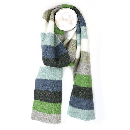 A colourful scarf featuring wide horizontal stripes in green, blue, grey, white, and black hangs against a white background—ideal for pairing with your favourite cosy winter accessories.