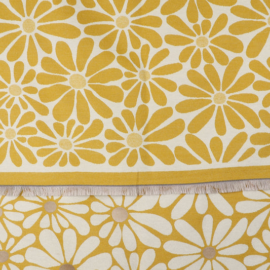 Yellow and white fabric featuring a striking floral daisy pattern and fringed edges, this Yellow Retro Daisy Scarf is laid flat with a section of the fringe clearly visible.