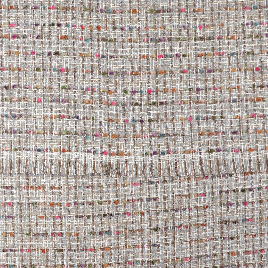 Close-up of a grey woven-texture scarf with a grid pattern, featuring multicoloured threads—pink, orange, green and purple—and a horizontal seam across the middle; a cosy winter accessory.