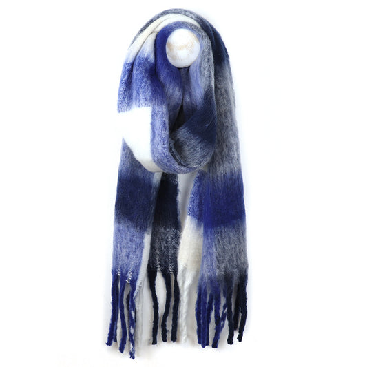 A long, fringed grey woven-texture scarf with a blue, white, and grey gradient pattern is hanging on a hook against a white background.