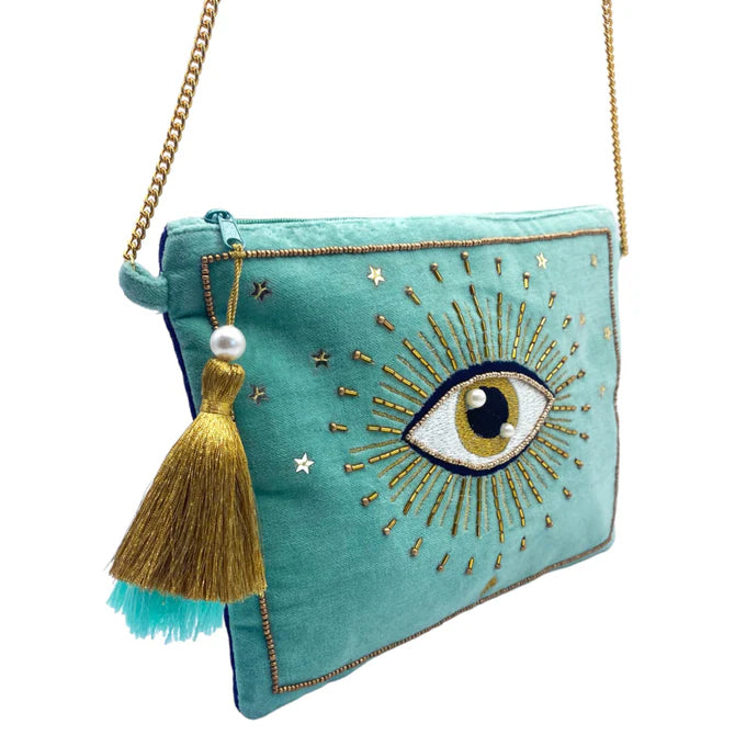 Teal Glimmer crossbody bag with gold chain strap, turquoise tassel, and an embroidered eye motif surrounded by gold rays and stars—a vegan-friendly accessory and the perfect Christmas present.