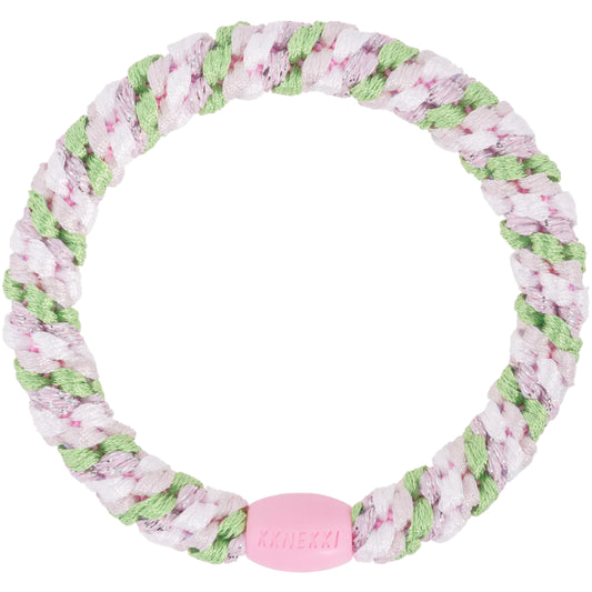 A circular plaited hair tie with pink, white, and green strands, featuring a pink connector embossed with Kknekki—perfectly combining practicality and style for your everyday needs.