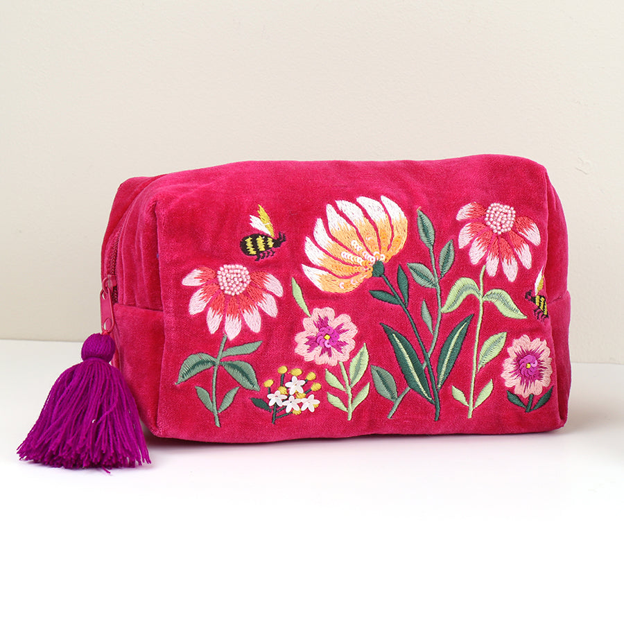 Stylish make-up bag in fuchsia velvet, featuring exquisite embroidery of flowers and bees, with a purple tassel on the zip.