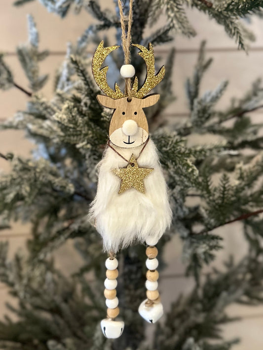 A handmade deer Christmas hanging decoration with gold antlers, a fluffy white body, beaded legs, and a glittery star makes a charming festive adornment for your Christmas tree.