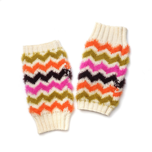 A pair of colourful winter accessories showcasing knitted arm or leg warmers with a zigzag pattern in orange, pink, olive green, black, and cream on a white background.