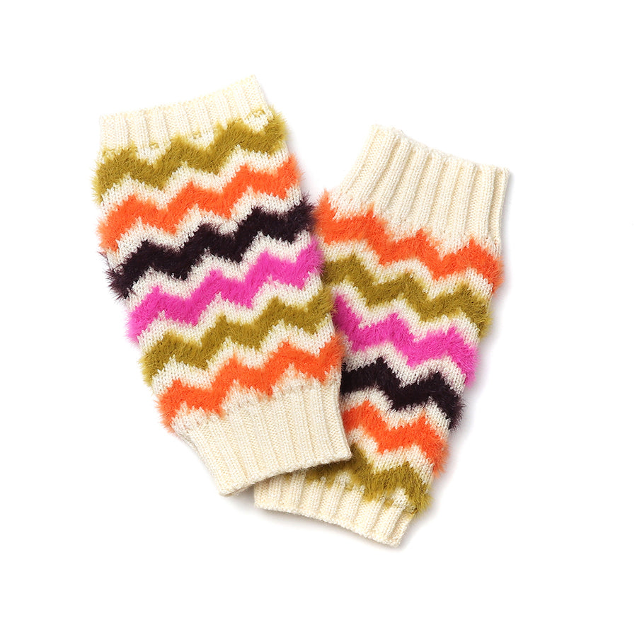 A pair of knitted cream-coloured leg warmers featuring zigzag stripes in olive green, orange, black, and pink—ideal for adding a splash to your colourful winter accessories collection.