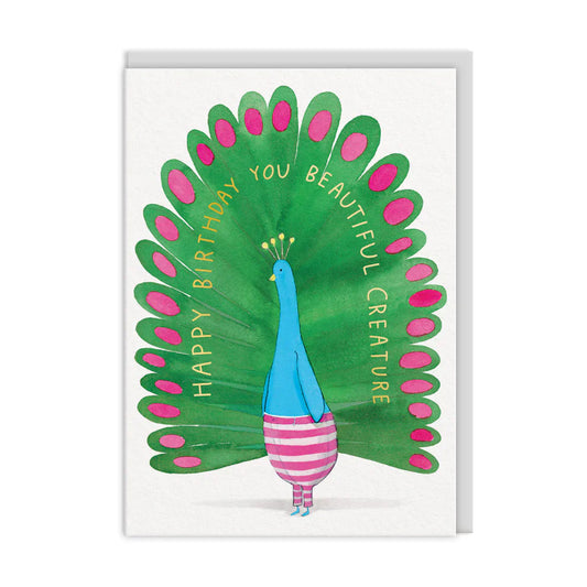 An illustrated peacock with colourful feathers and striped legs, standing upright. The text on the feathers reads, Happy Birthday You Beautiful Creature. Perfect compliments from E Frances Paper for a stunning birthday card.