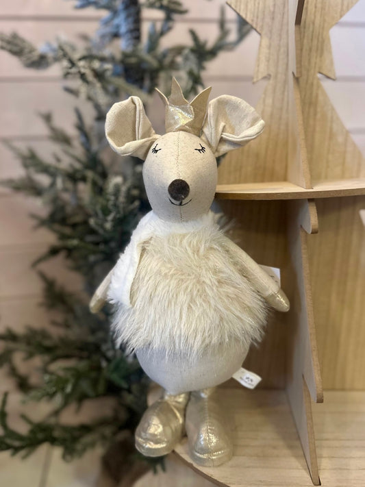 A standing Christmas mouse plush with a gold crown, closed eyes, fluffy white belly, and metallic gold feet stands before a tree and wooden display—ideal as festive decoration or holiday décor.