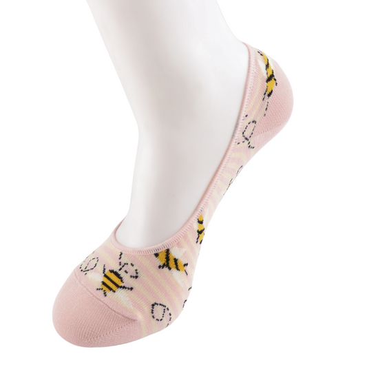 A mannequin foot is wearing a pink invisible footsie sock featuring a pattern of yellow and black cartoon bees, offering considered luxury in a vegan-friendly design.