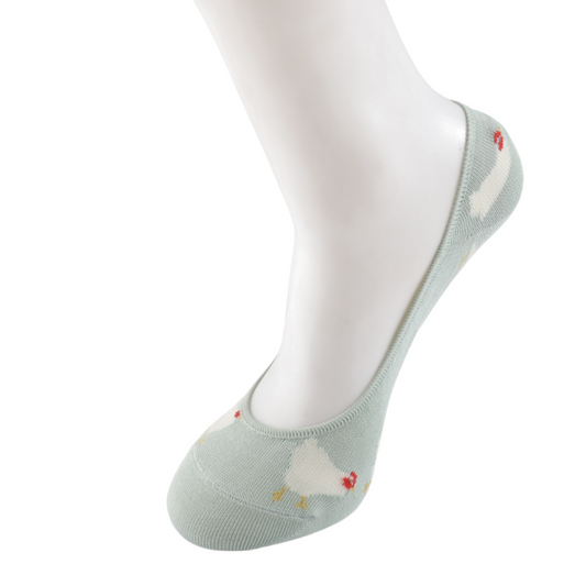 A mannequin foot displays the British-designed, vegan-friendly Light Blue Hens Invisible Footsie Socks, featuring a light green base, a white chicken pattern, and red accents against a white background.