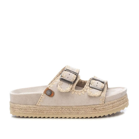 Beige double-buckle sandal featuring a vegan suede-like upper, two adjustable straps, and braided detailing along the sole.