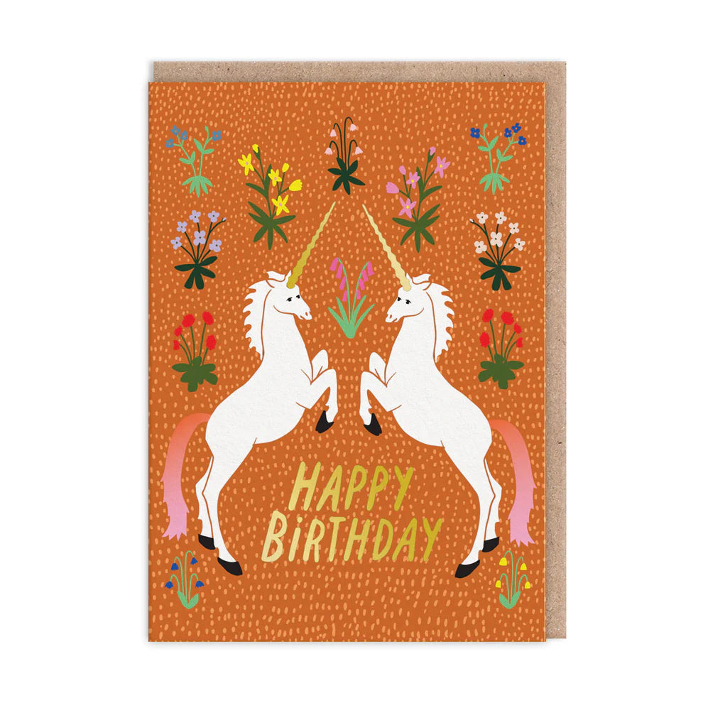 Birthday card featuring two unicorns facing each other on an orange background, surrounded by vibrant meadow flowers. The words Happy Birthday grace the centre, adding a touch of floral imagery to your special day.