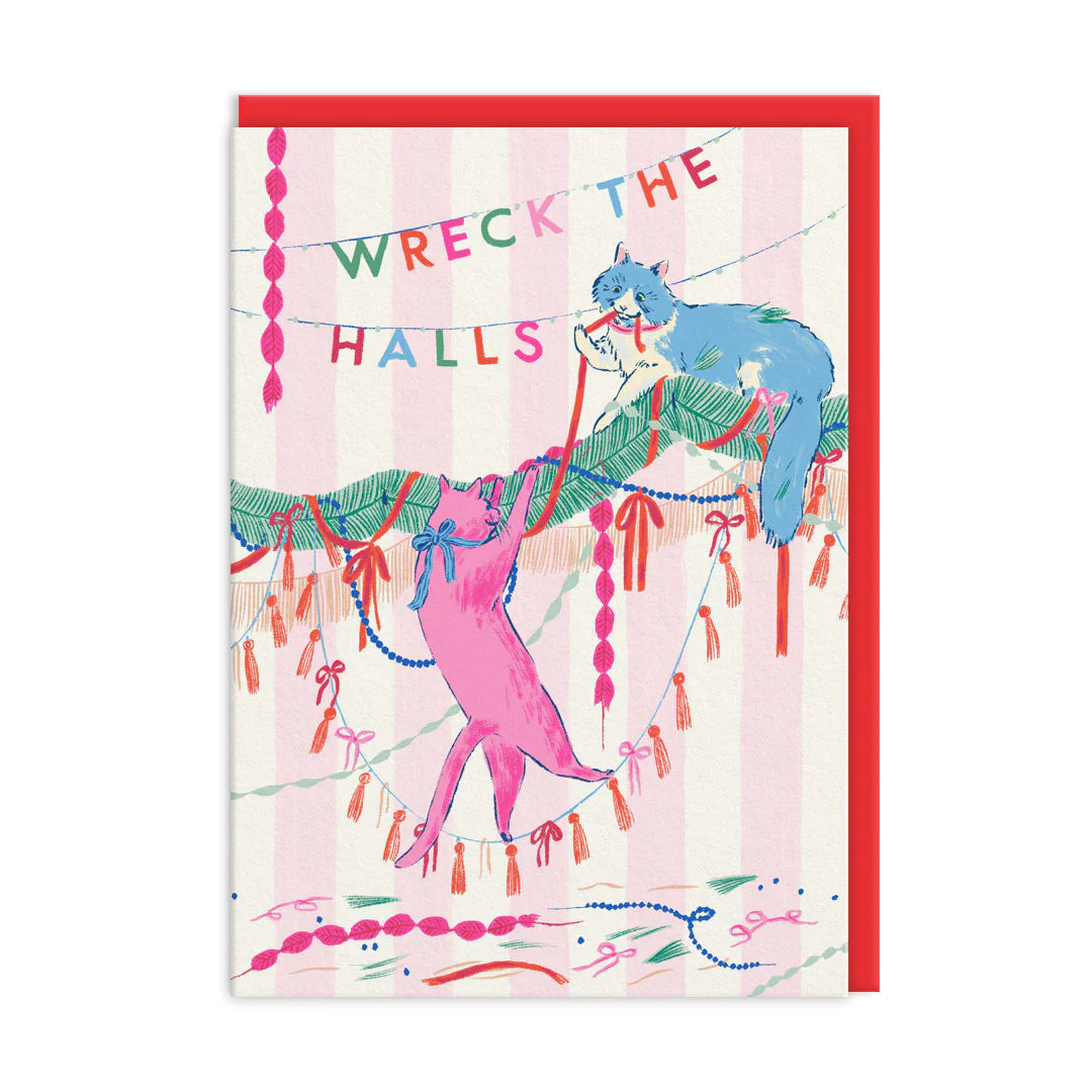 Illustration of two cats tangled in festive decorations beneath a banner reading Wreck the Halls, set against a pink and white striped background; an ideal Christmas card for cat lovers.