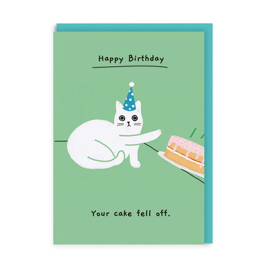 A white cat in a party hat knocks a pink-iced cake off the table. The card says Happy Birthday. Your cake’s toppled—a humorous birthday card brimming with feline wit!.