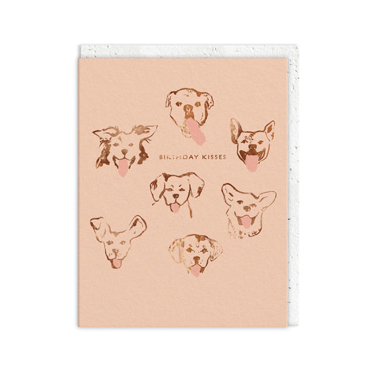 Greeting card featuring sketches of seven dogs’ faces, all with tongues out, and the words BIRTHDAY KISSES printed in the centre—a perfect Birthday Kisses Card for sending some playful doggy kisses.