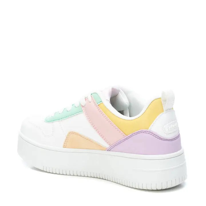 Low Top Pastel Trainers crafted from vegan leather, featuring pastel green, peach, yellow, and purple accents on a thick rubber platform sole, viewed stylishly from the rear.
