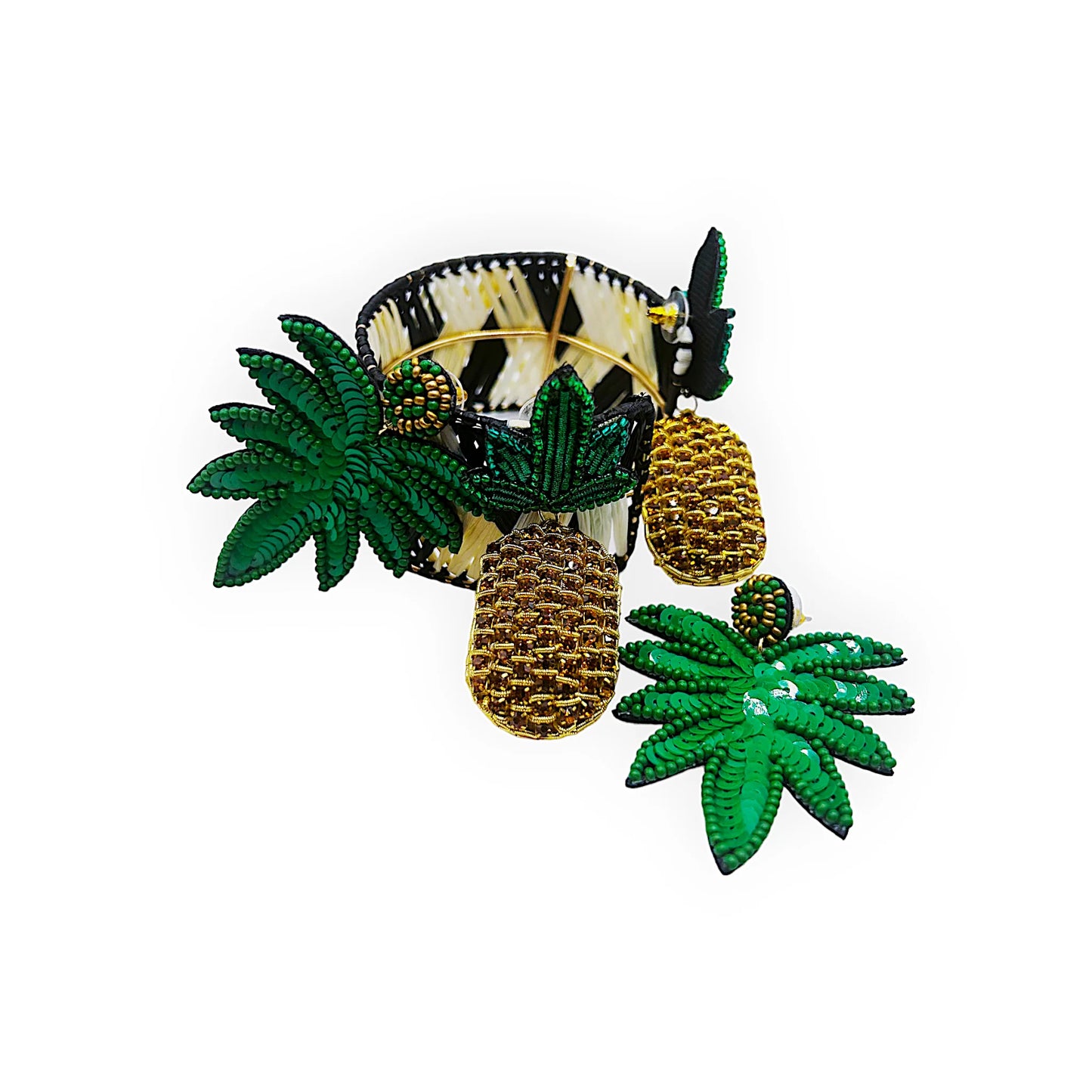 A black and beige woven bracelet featuring a tropical design with green beaded leaves and two gold and brown beaded pineapple charms.