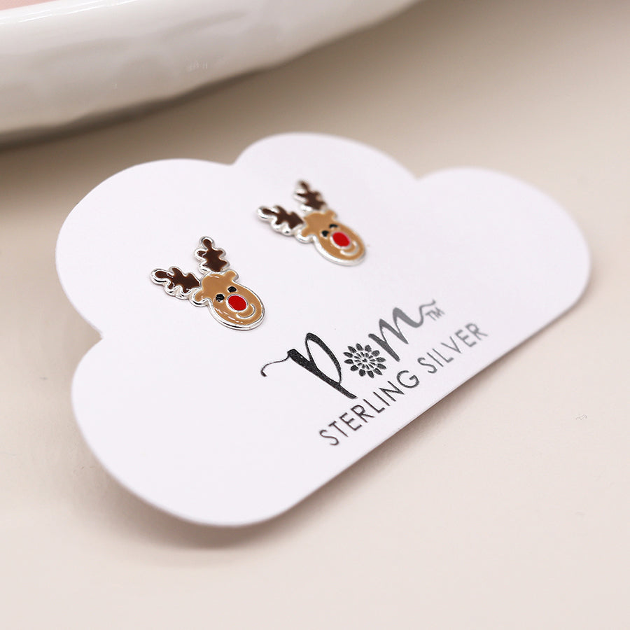 A pair of sterling silver reindeer earrings with red noses, displayed on a cloud-shaped card labelled POM STERLING SILVER—the ideal festive jewellery for the holiday season.