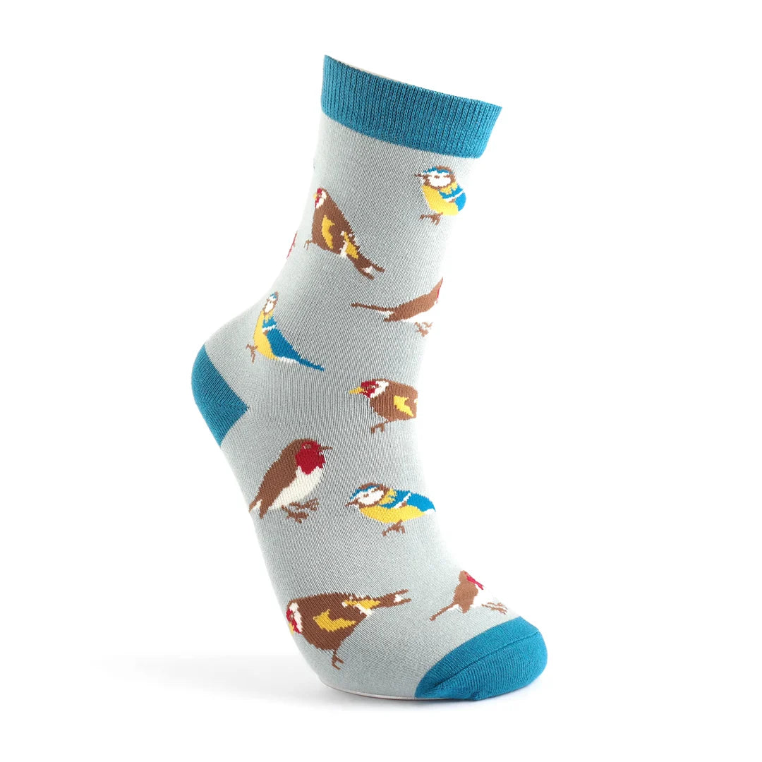 A light grey Garden Birds Sock with teal heel, toe, and cuff, featuring a pattern of colourful birds in various poses. Made from vegan-friendly bamboo blend for comfort and sustainability.