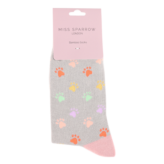 A pair of vegan-friendly mid-grey socks crafted from a bamboo-rich blend, featuring colourful paw prints and a pink toe, labelled Miss Sparrow London Bamboo Socks.