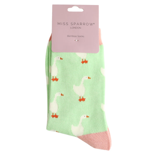 A pair of pastel green Goose Mint socks featuring a white goose pattern with pink heels and toes, made from bamboo and cotton, labelled Miss Sparrow London—perfect vegan-friendly accessories.