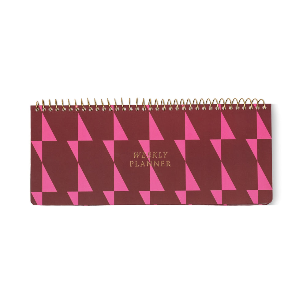 A spiral-bound Weekly Planner Pad featuring a maroon and pink geometric cover design, with gold lettering that reads WEEKLY PLANNER—ideal as a planner for professionals.