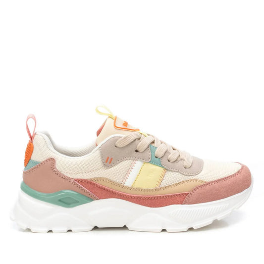 A beige multicoloured trainer featuring a chunky white non-slip rubber sole, beige mesh upper, pink and tan suede accents, and vibrant yellow, teal, and orange details.