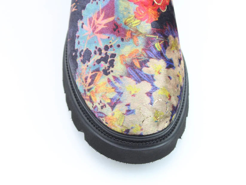 Close-up of the toe of the Zeta Black Floral Boots, showing a black sole and lively floral fabric pattern, made as vegan boots with a comfortable memory foam footbed.