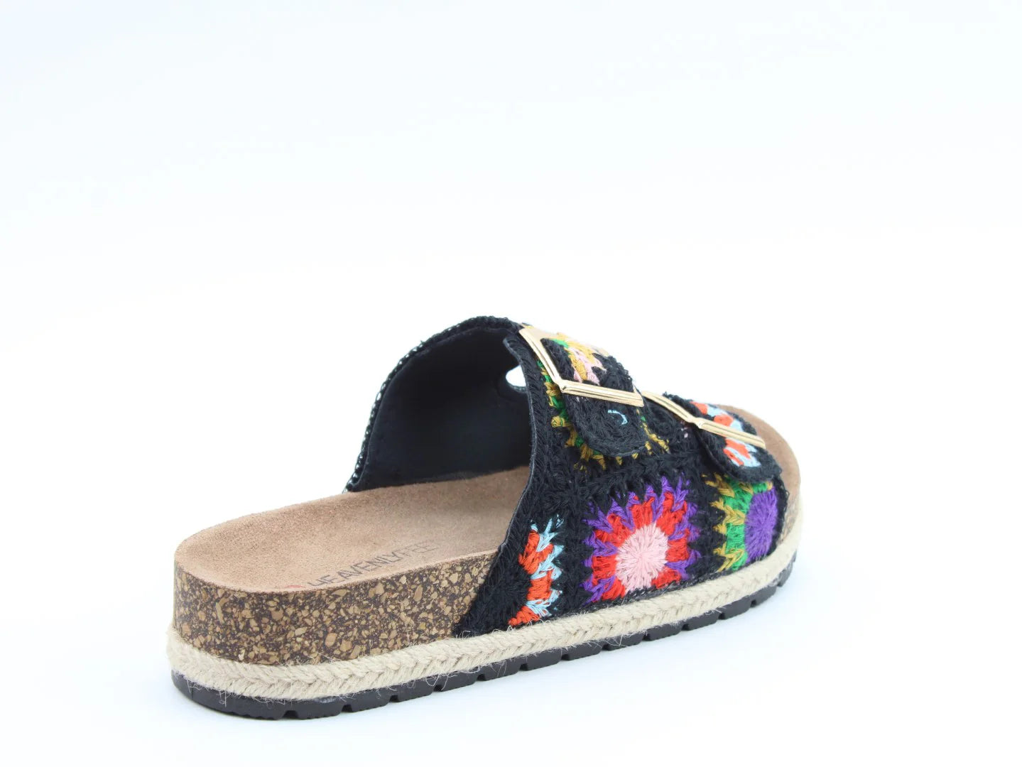 A single open-toe sandal with a cork sole, colourful stitched upper in black fabric, bright crocheted flower designs, and a gold buckle on the strap, featuring a contoured footbed for added comfort.