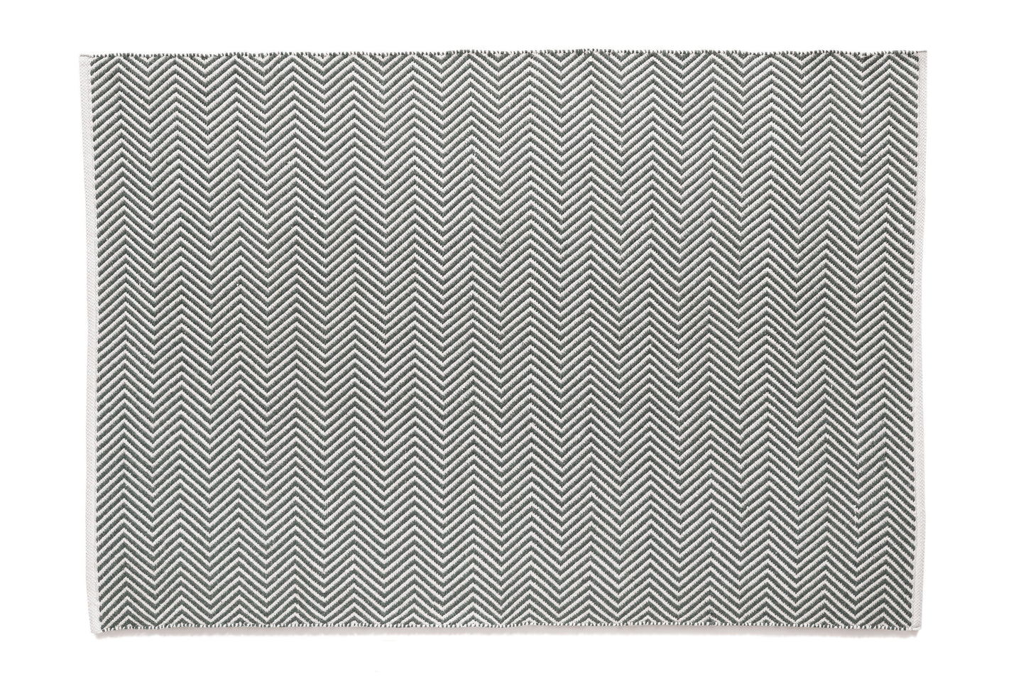 This rectangular, monochrome rug features a UV-stable design with a repeating chevron pattern in black and white, sustainably crafted from recycled plastic bottles.